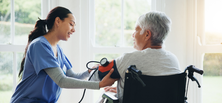 a medical assistant takes the blood pressure of a patient in a wheelchair