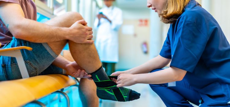 podiatry assistant wraps a patient's ankle
